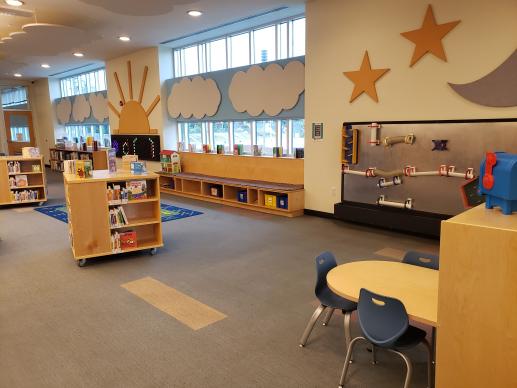 The writing table, ball wall, and board books in the children's area.