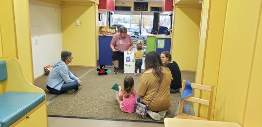 Sherry Hess on the Learn & Play Bus during a storytime. One our community partners from the Health Department was on board.