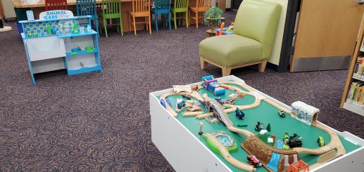 Two of the most popular toys are the train table and the animal care center