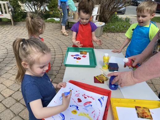 Children outside using finger paints