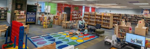 View of MPL Children's Room.  Shows toys and book shelves.  Colorful rug in the middle.  