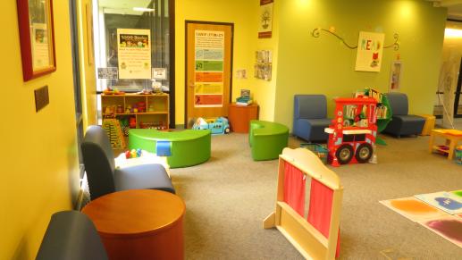 Our early childhood play space with poster on early literacy teaching parents about the importance of talk, sing, read, write and play.