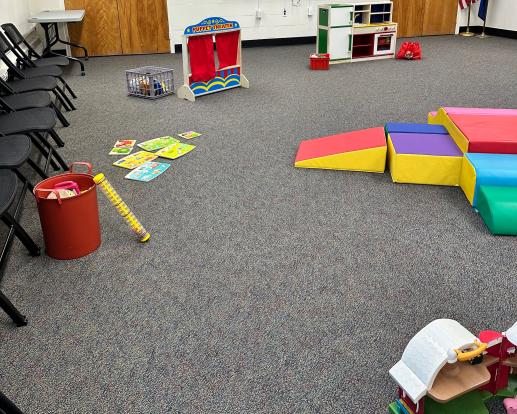 A small area of the Parent Child Workshop including a puppet theater, kitchen, puzzles, and music