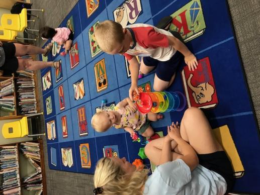 Mother and her two children playing at a Family Place workshop