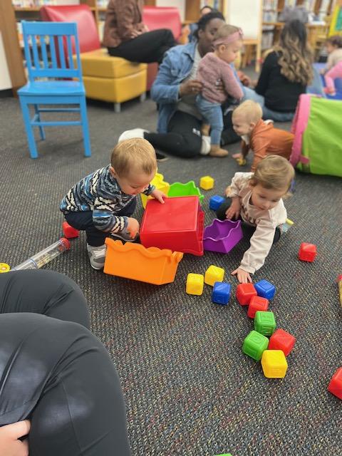 Two toddlers playing together during our Family Place Workshop