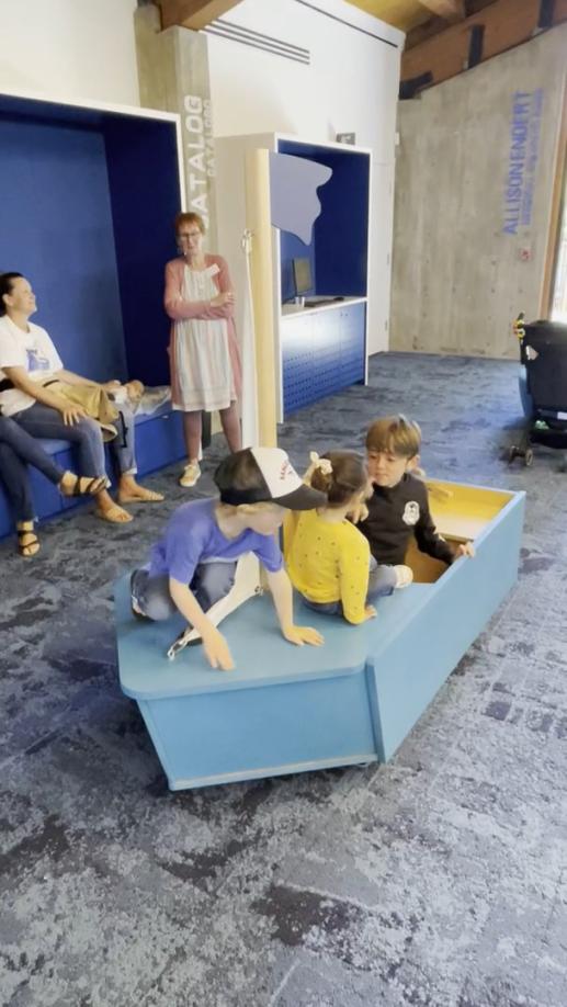 Three children playing in the sailboat in the newly remodelled Children's Room at the Branciforte Branch Library