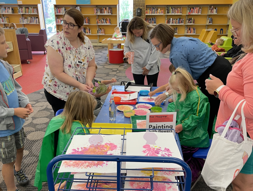 Children painting with flowers