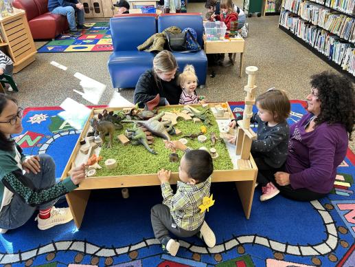 Children playing with caregivers in preschool area in the Mt Lebanon Public Library