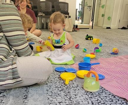 Children and caregivers playing at the Discovery Play Zone program