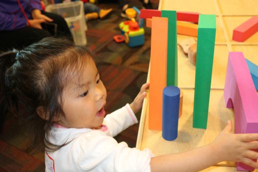 Child playing with colored foam building blocks on PAL Island