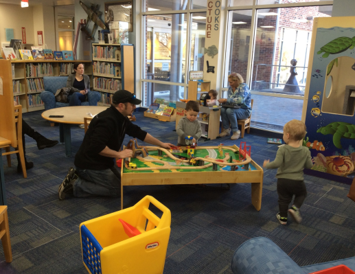 Library patrons enjoy the train table and toy grocery store.