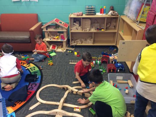 Children building train tracks.