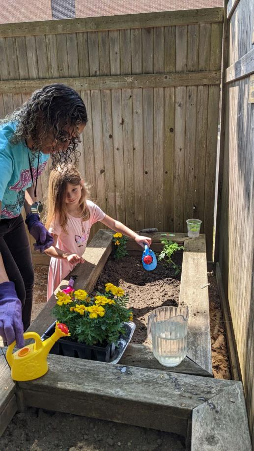 Librarian and patron enjoy the Discovery Backyard.